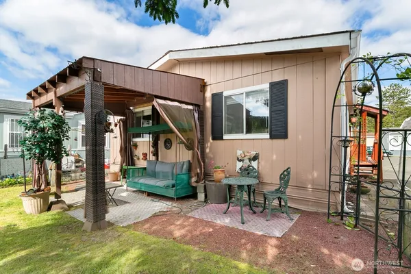 a view of a chair and table in backyard of the house