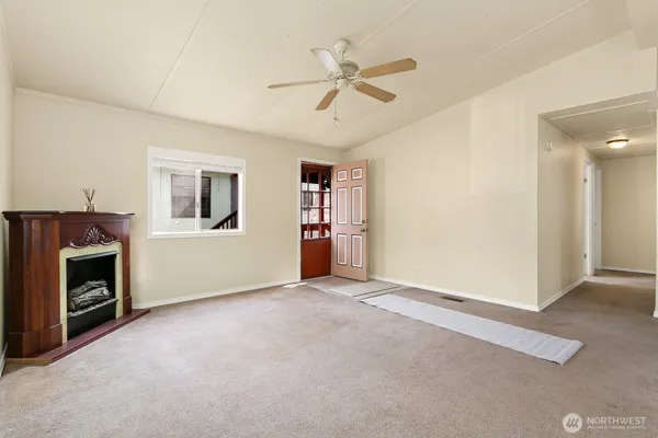 a view of an empty room with a fireplace
