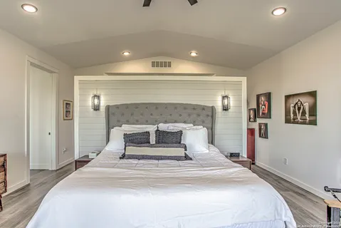 a spacious bedroom with a bed and a fireplace