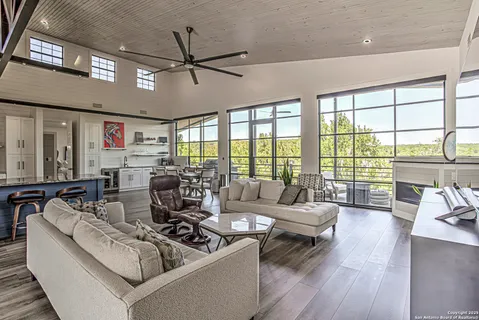 a living room with furniture and floor to ceiling windows