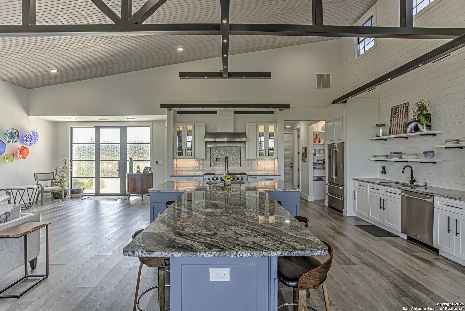 2705 Campestres Spring Branch, TX 78070 - Photo 25 of 35 a kitchen with stainless steel appliances granite countertop a kitchen island a stove and a wooden floors