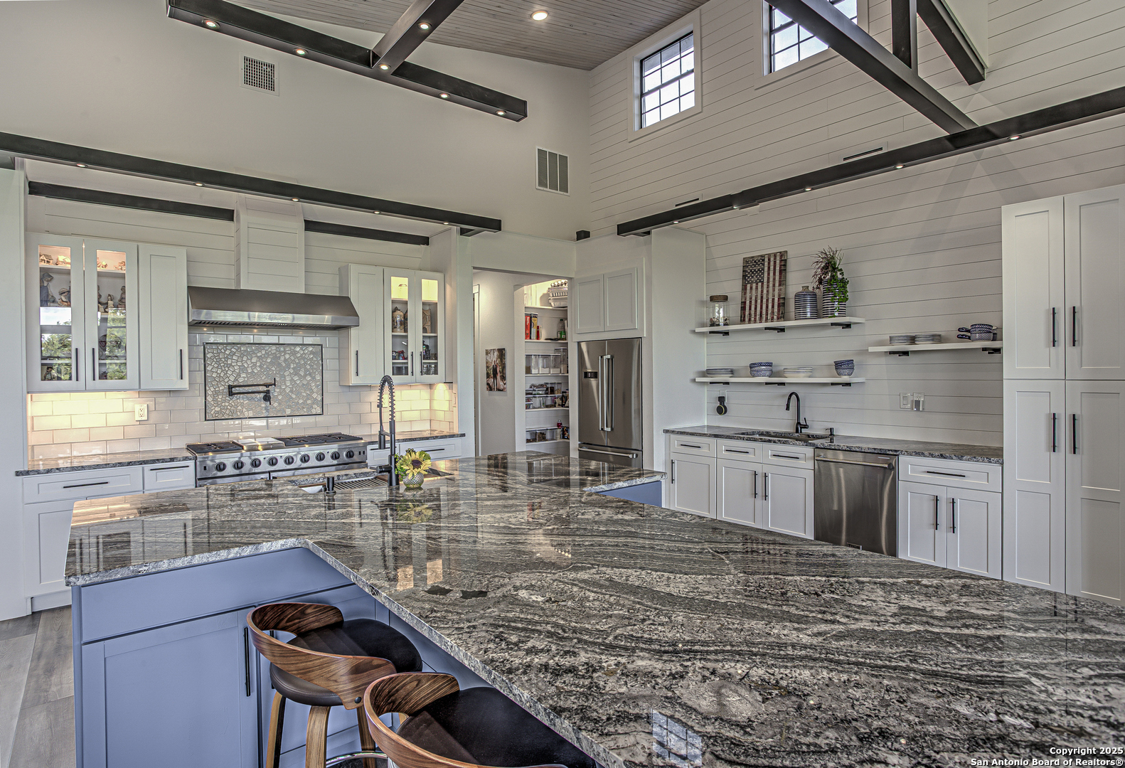 2705 Campestres Spring Branch, TX 78070 - Photo 26 of 35 a kitchen with kitchen island a stove a sink and a refrigerator