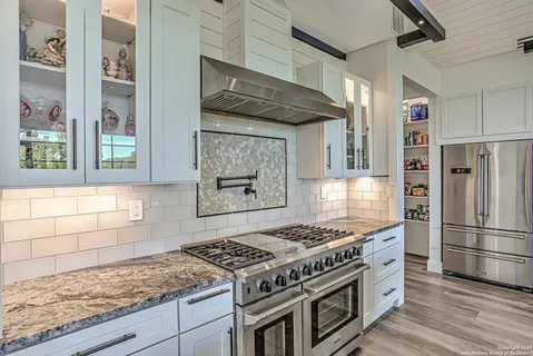 a kitchen with stainless steel appliances granite countertop a stove and a refrigerator