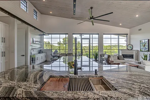 a living room with furniture and a floor to ceiling window