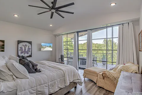 a bedroom with a large bed and a large window