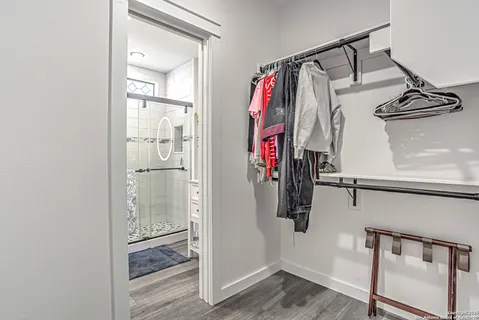 a view of walk in closet with clothes and shoes