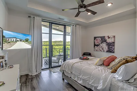 a bedroom with a bed and a large window