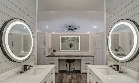 a bathroom with a sink a mirror and a toilet