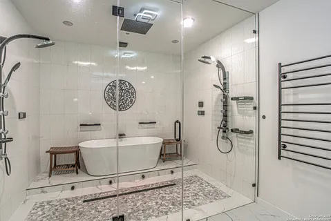 a bathroom with a sink a mirror and a shower
