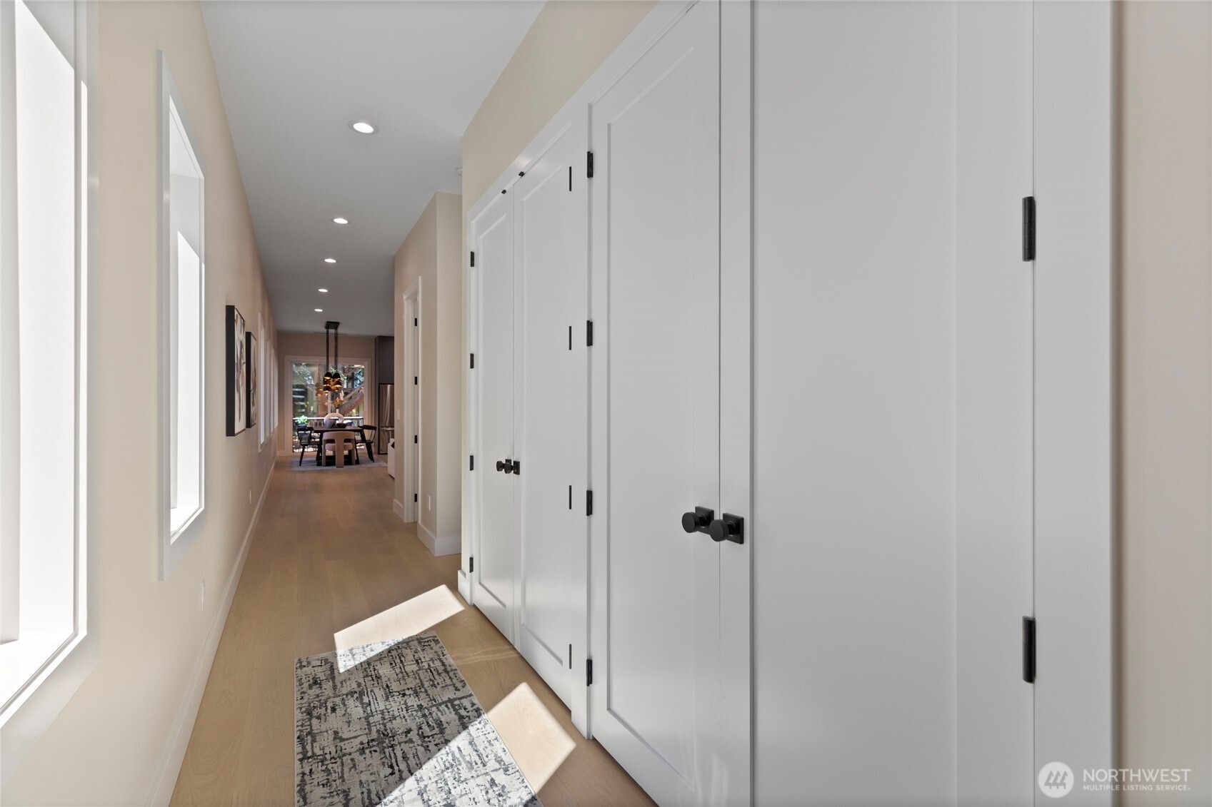 6543 Chapin Place North Seattle, WA 98103 - Photo 18 of 40 a view of a hallway with wooden floor and a living room