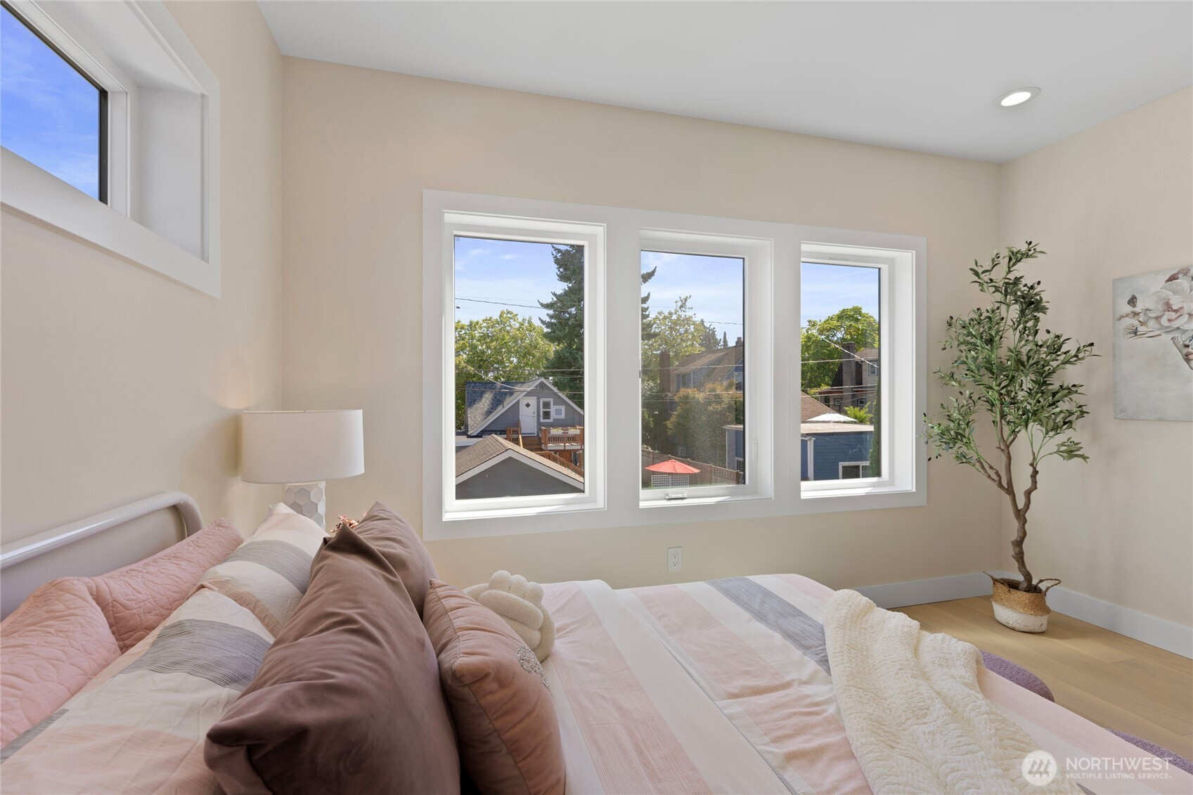 6543 Chapin Place North Seattle, WA 98103 - Photo 19 of 40 a bed sitting in a bedroom next to a window