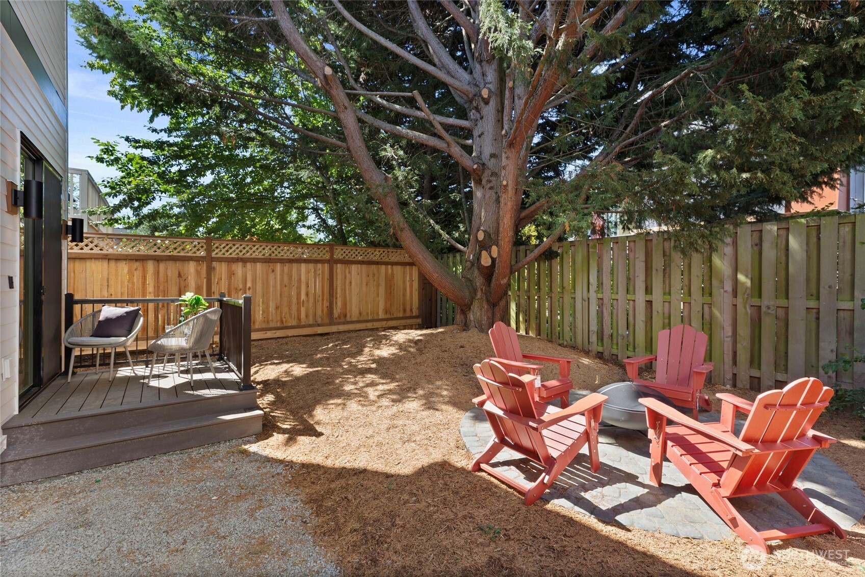 6543 Chapin Place North Seattle, WA 98103 - Photo 31 of 40 a view of backyard with table and chairs and a large tree
