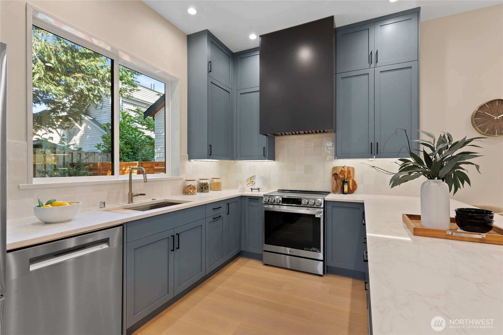 6543 Chapin Place North Seattle, WA 98103 - Photo 9 of 40 a kitchen with stainless steel appliances granite countertop a sink stove and cabinets