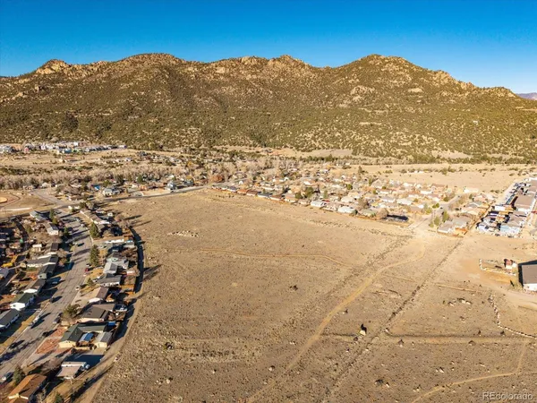 a view of a large building with mountains in the background