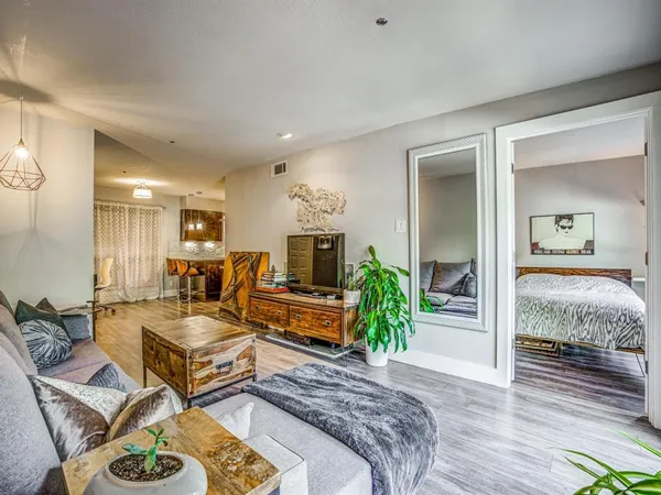 a living room with patio furniture and a wooden floor