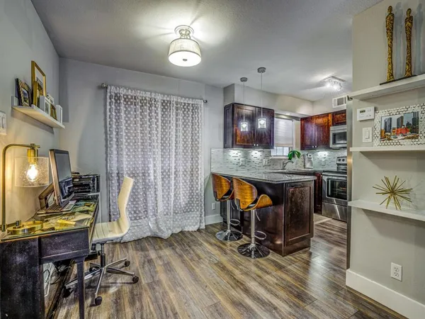 a view of a dining room with furniture and wooden floor