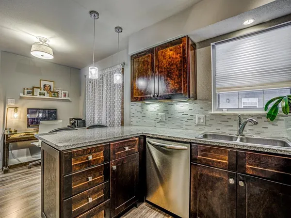 a kitchen with stainless steel appliances granite countertop a sink stove and cabinets