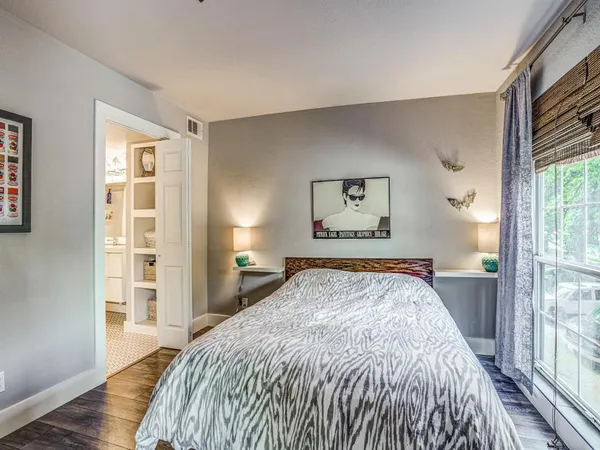 a bedroom with a large bed and a window