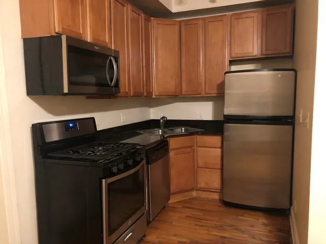 a kitchen with a refrigerator stove and microwave