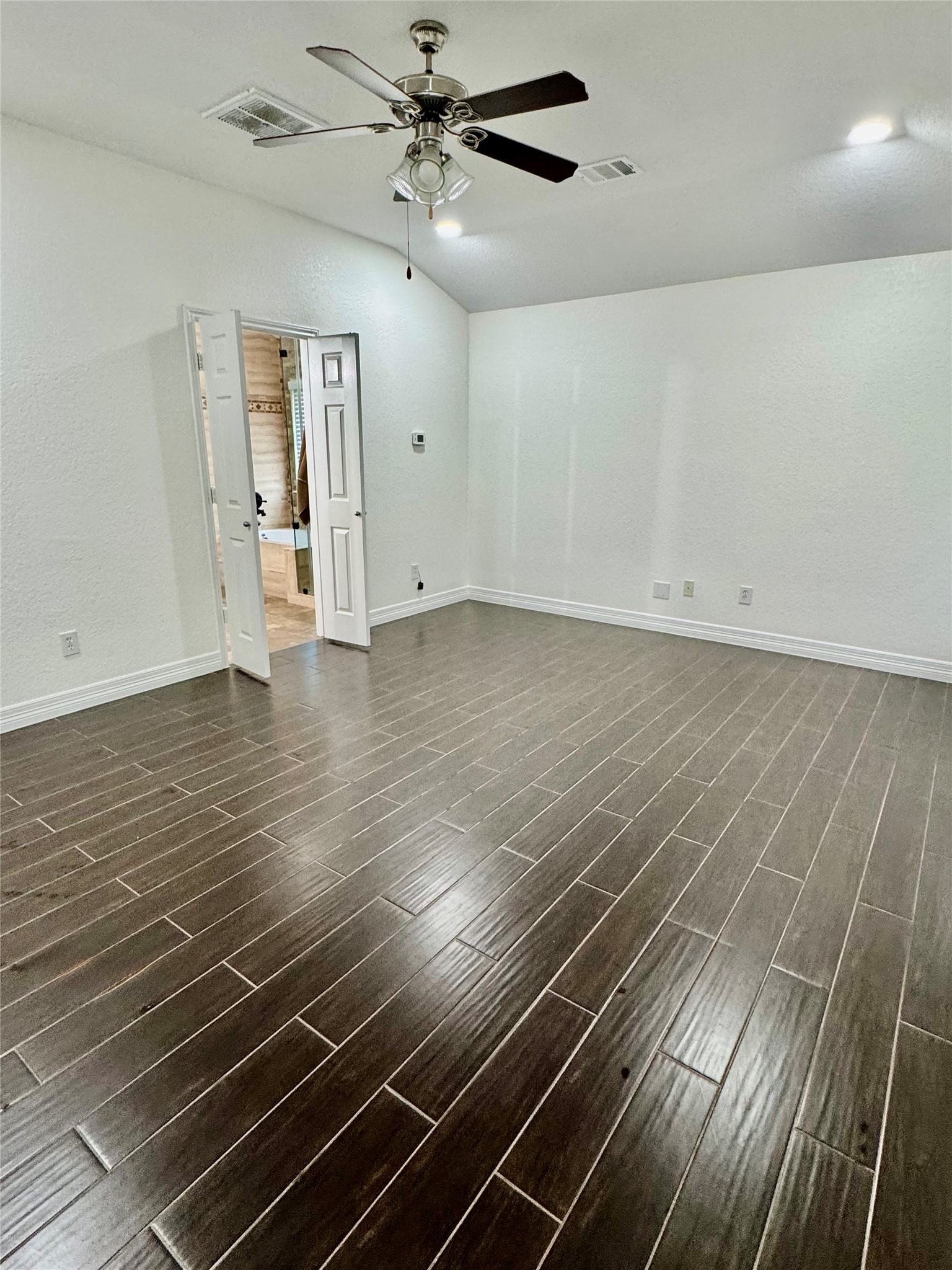 21424 Quail Point Lane Porter, TX 77365 - Photo 28 of 49 a view of an empty room with wooden floor and a ceiling fan
