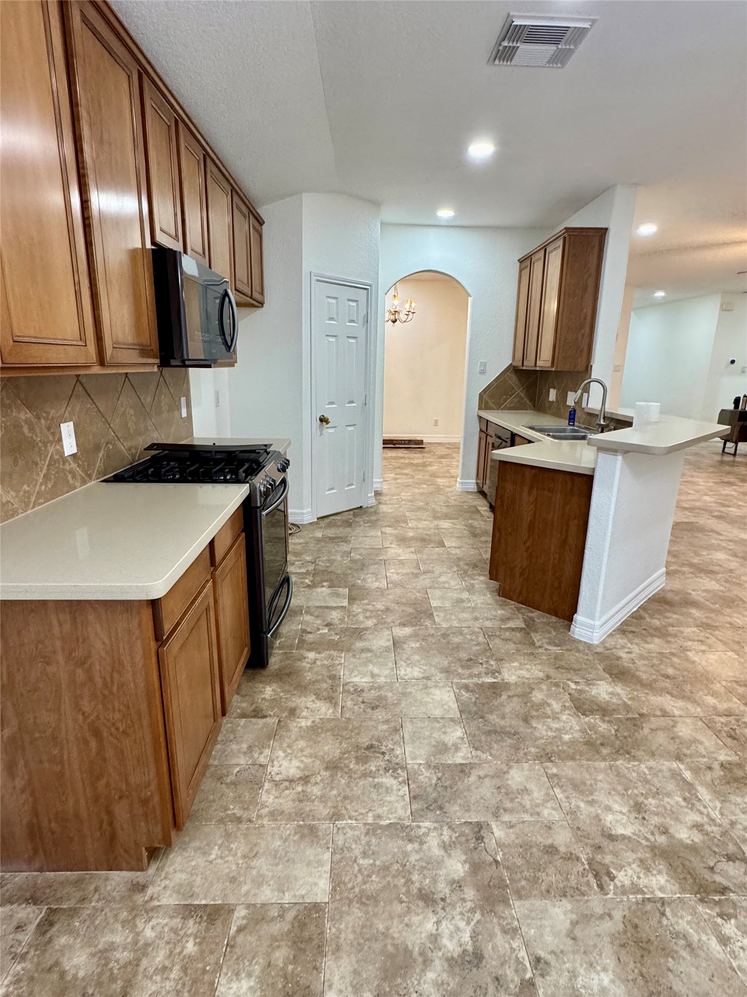 21424 Quail Point Lane Porter, TX 77365 - Photo 41 of 49 a kitchen with stainless steel appliances granite countertop a sink stove and cabinets