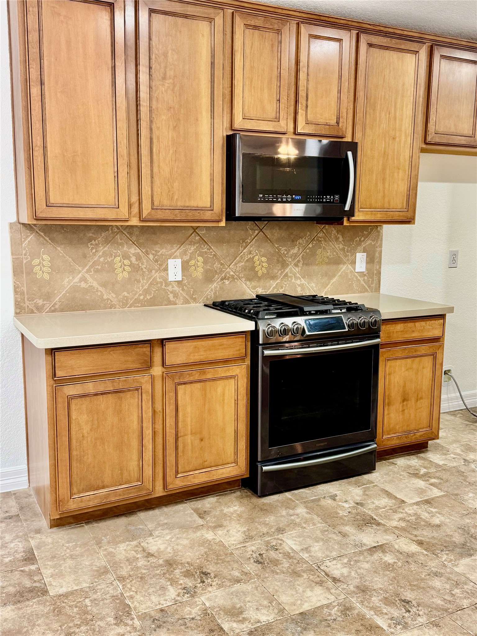 21424 Quail Point Lane Porter, TX 77365 - Photo 42 of 49 a kitchen with stainless steel appliances granite countertop a stove a microwave and a sink