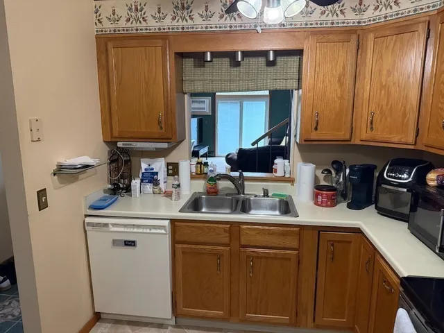 a kitchen with a sink a stove and cabinets