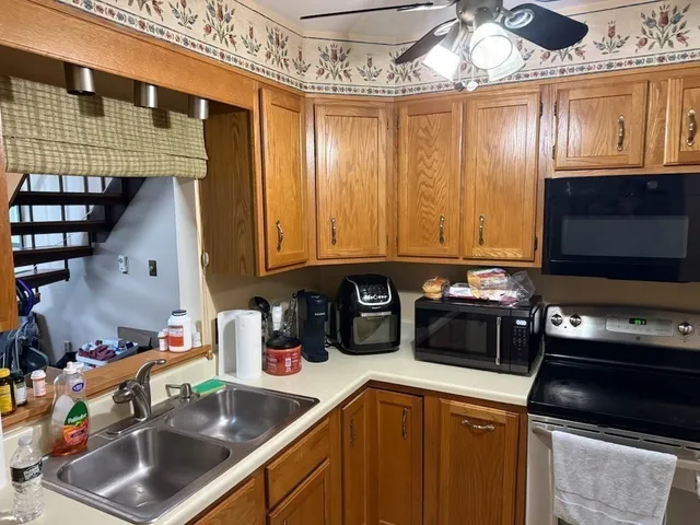 a kitchen with a sink a stove and cabinets