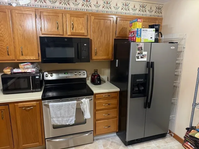 a kitchen with stainless steel appliances a refrigerator a stove and a microwave