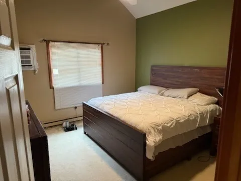 a bed sitting in a bedroom next to a window