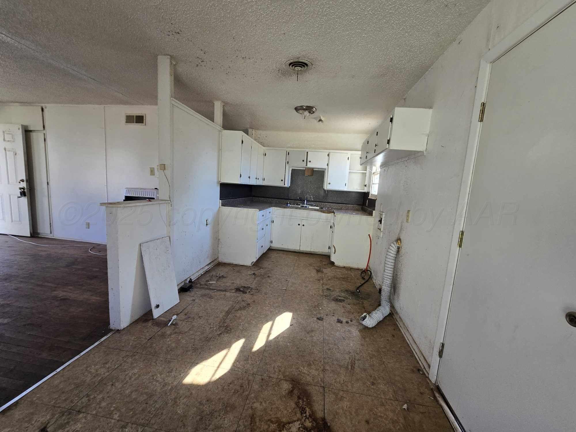 508 South Collins Avenue Tulia, TX 79088 - Photo 4 of 11 a view of a storage & utility room with cabinets