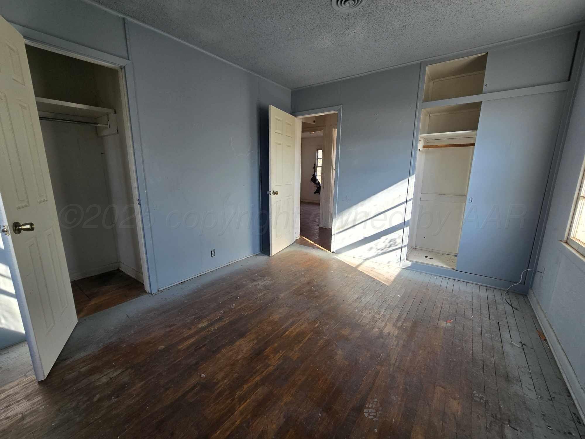508 South Collins Avenue Tulia, TX 79088 - Photo 10 of 11 a view of empty room with wooden floor and fan