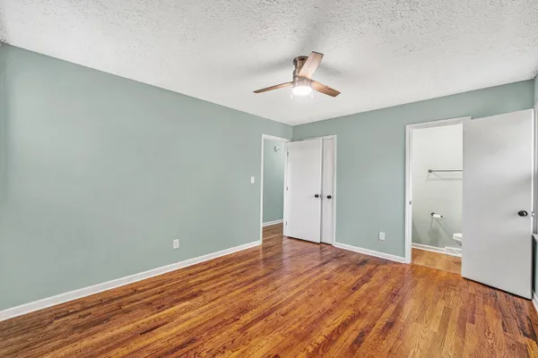 a view of an empty room with wooden floor