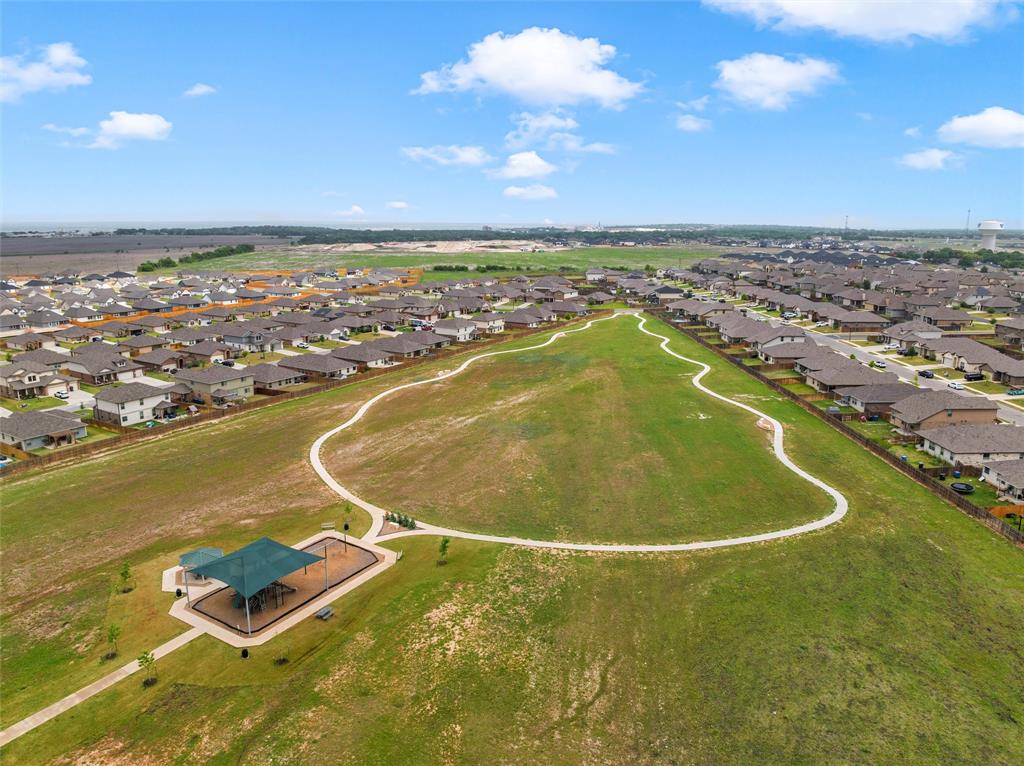 3208 Dottavio Road Lorena, TX 76655 - Photo 26 of 31 Expansive green space featuring a paved walking path, a covered pavilion, and surrounding residential properties