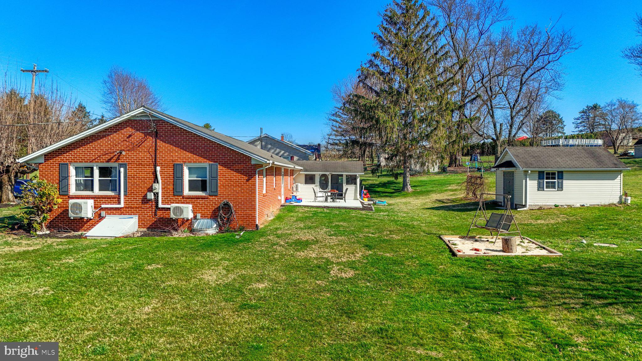 5571 Blooming Grove Road Glenville, PA 17329 - Photo 2 of 29 a front view of a house with a yard table and chairs