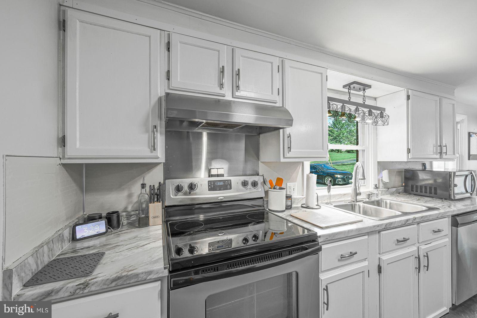 5571 Blooming Grove Road Glenville, PA 17329 - Photo 6 of 29 a kitchen with granite countertop a sink cabinets stainless steel appliances and a window
