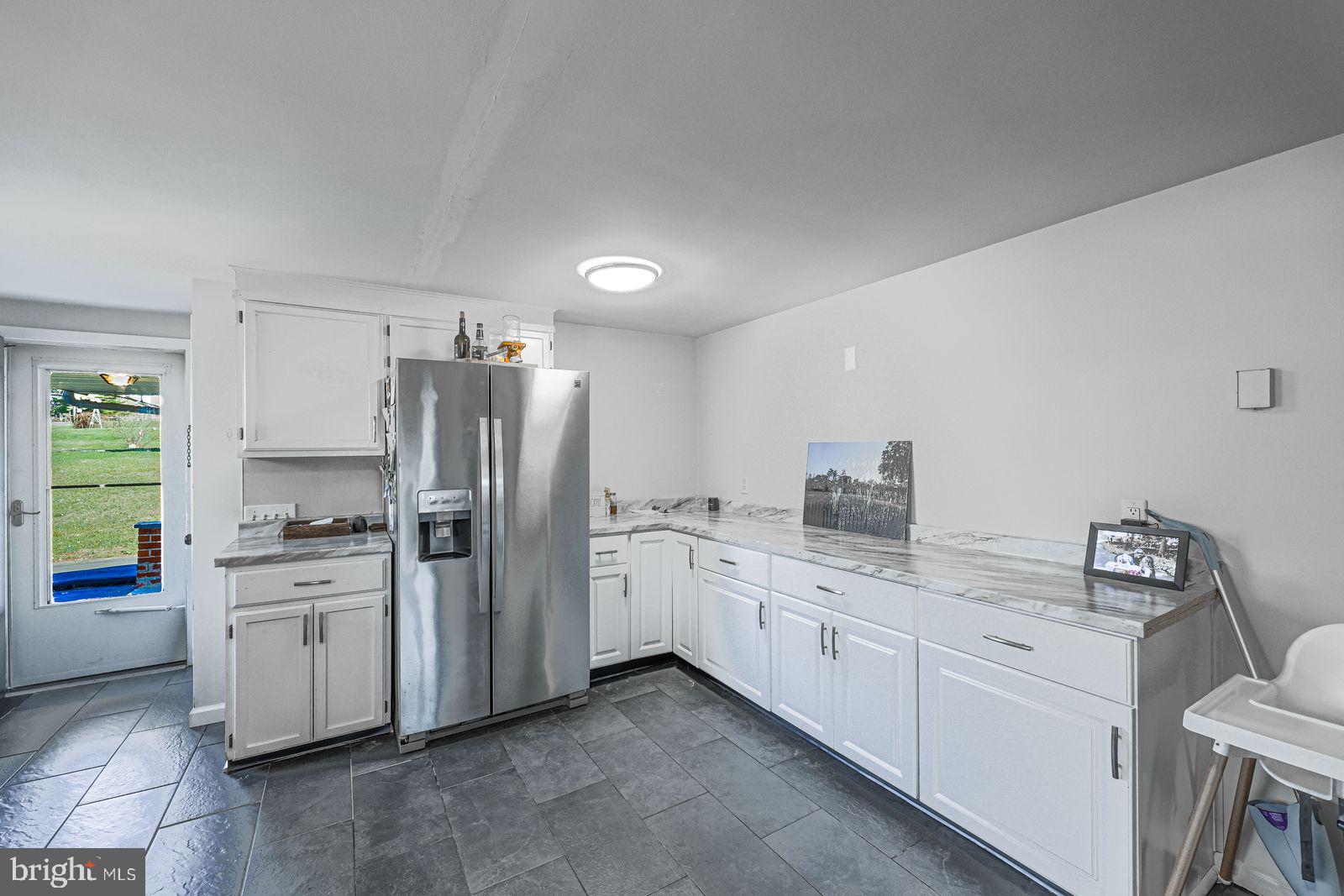 5571 Blooming Grove Road Glenville, PA 17329 - Photo 7 of 29 a kitchen with white cabinets and appliances