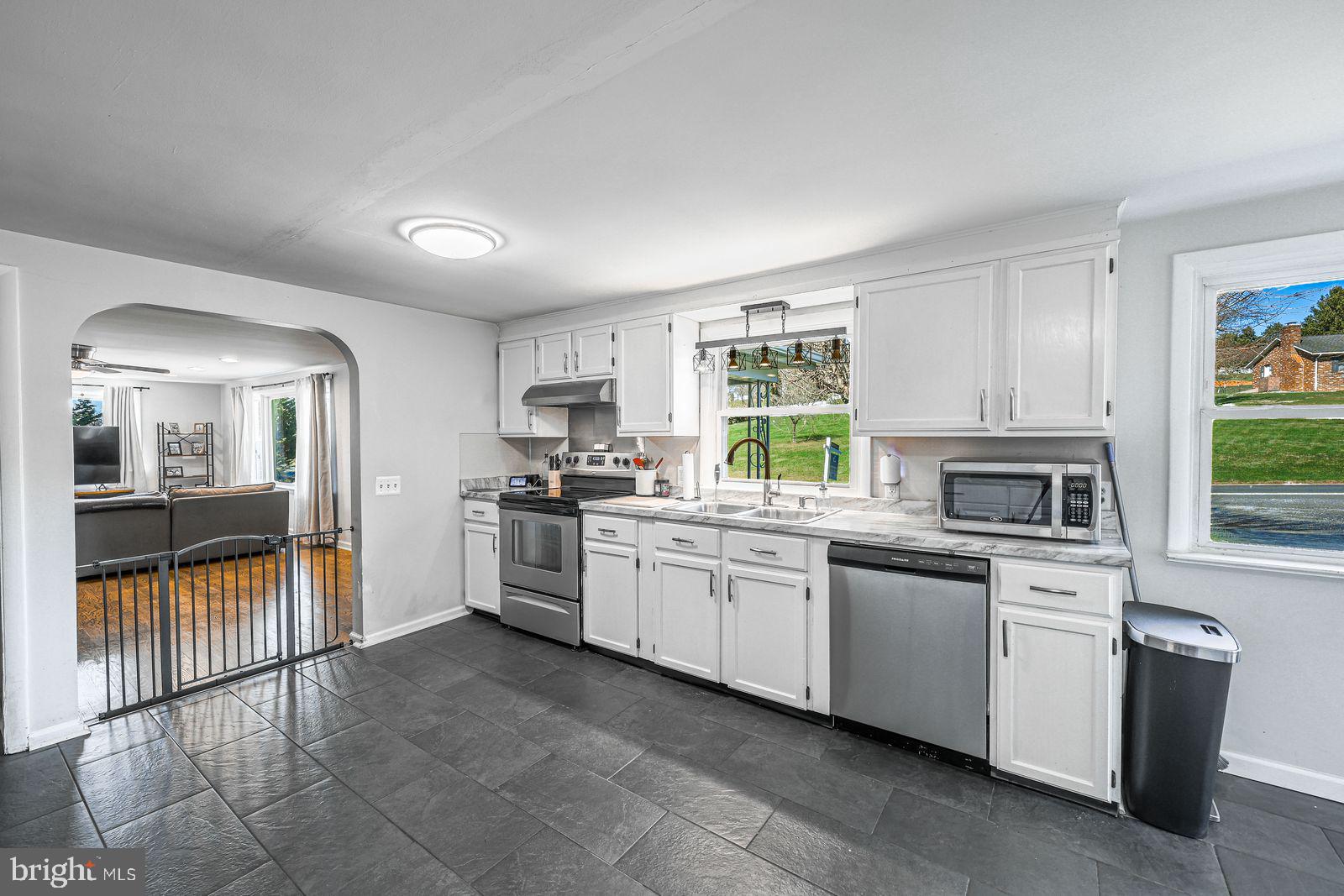 5571 Blooming Grove Road Glenville, PA 17329 - Photo 8 of 29 a kitchen with granite countertop a stove top oven sink and cabinets