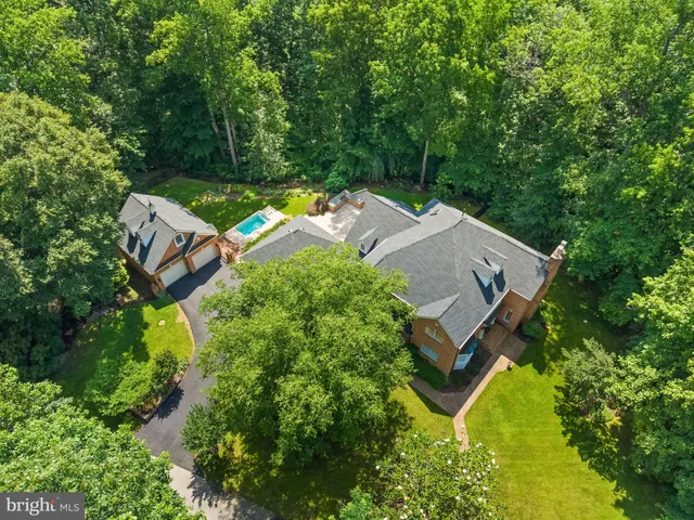 an aerial view of a house with garden space and street view