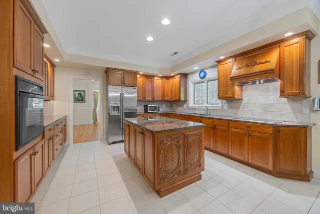 a kitchen that has a lot of cabinets in it and wooden floors