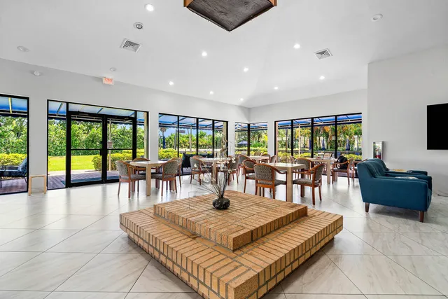 a view of sign board with yard and trees