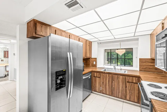 a kitchen with stainless steel appliances a refrigerator and a sink