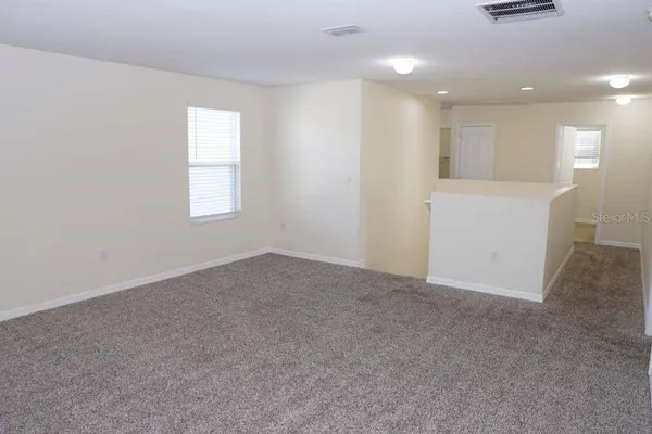 an empty room with windows and closet