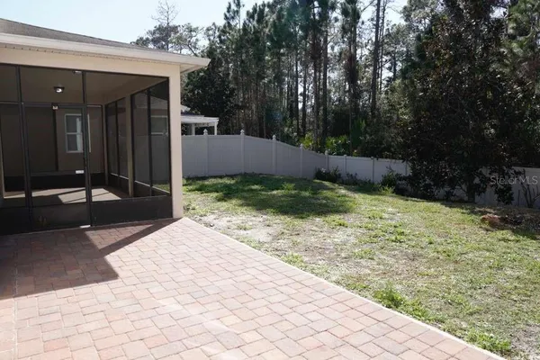 a view of a backyard of the house