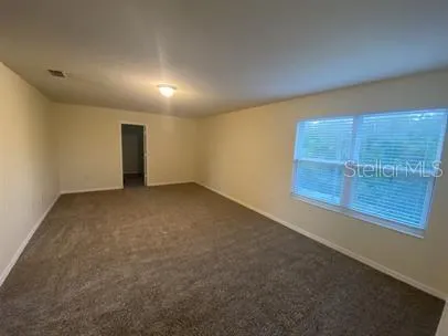 a bathroom with a granite countertop sink toilet and mirror