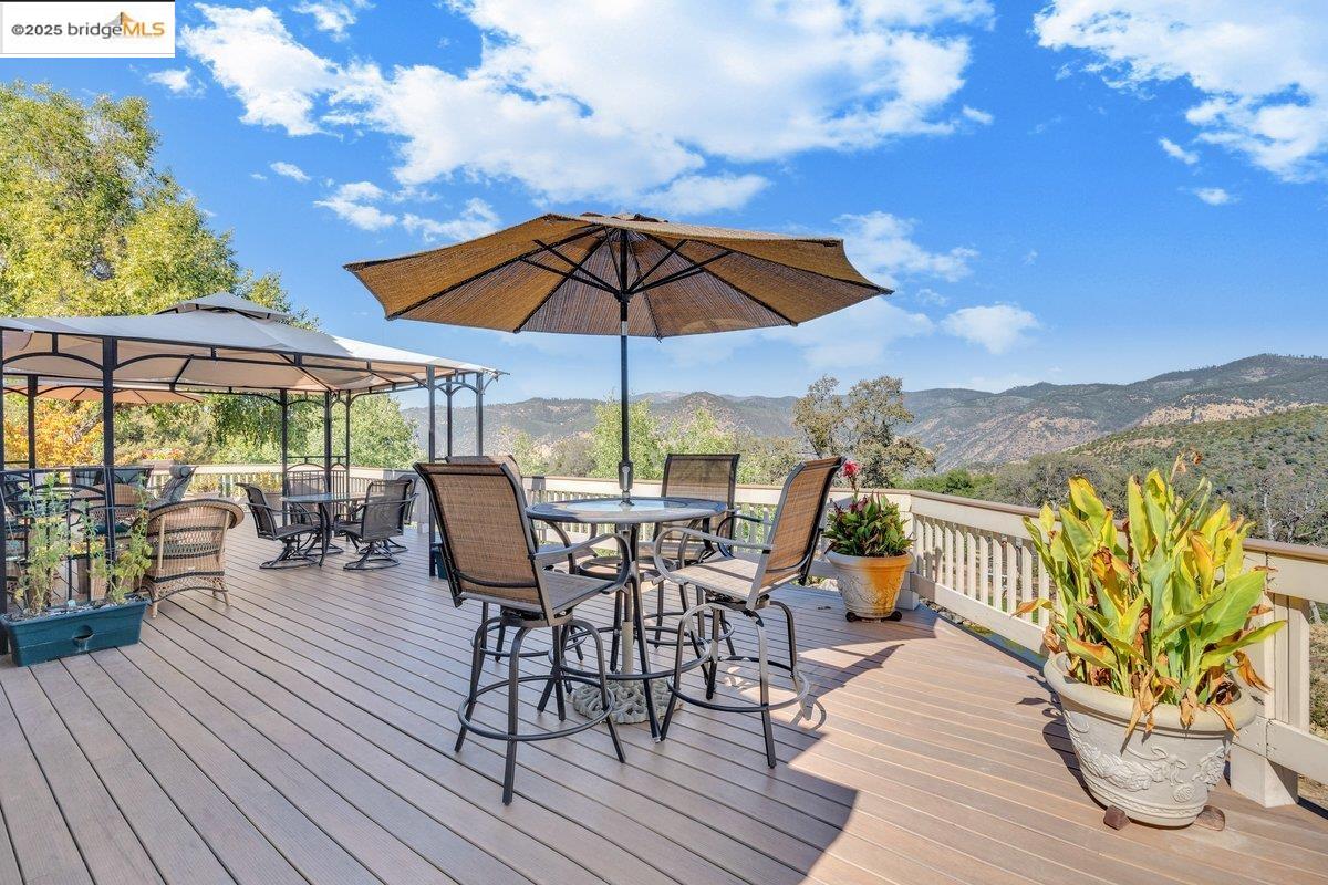13700 Clements Road Groveland, CA 95321 - Photo 55 of 93 Wooden deck featuring a mountain view, a gazebo, and outdoor dining area