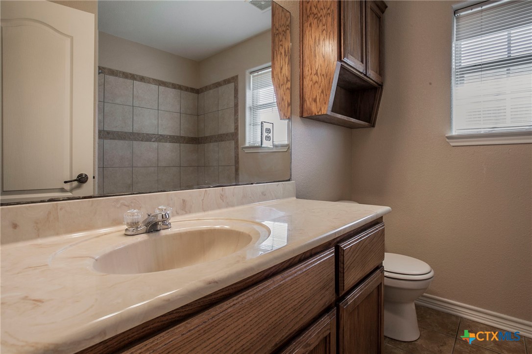 3710 Dewitt County Court Killeen, TX 76549 - Photo 11 of 18 a bathroom with a sink a toilet and a mirror