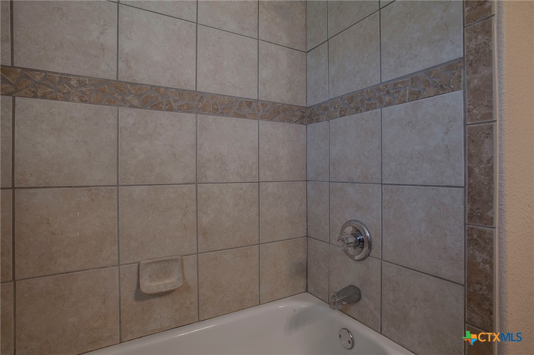 3710 Dewitt County Court Killeen, TX 76549 - Photo 12 of 18 a bathroom with a bathtub and shower