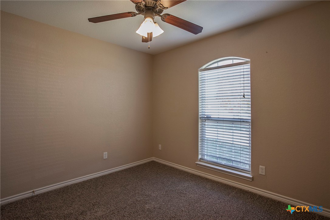 3710 Dewitt County Court Killeen, TX 76549 - Photo 13 of 18 an empty room with a window and a fan