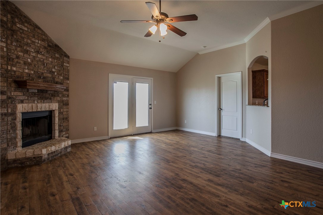 3710 Dewitt County Court Killeen, TX 76549 - Photo 3 of 18 a view of an empty room with wooden floor fireplace and a window